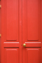 Fototapeta premium Door knob golden color with red door background