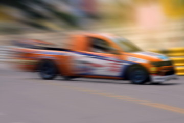 Race car racing on speed track with motion blur