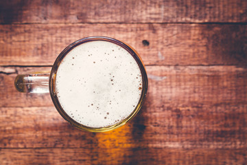 Glass of beer on wooden table