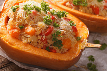 Baked pumpkin stuffed with couscous, meat and vegetables macro. horizontal