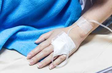 Woman on a drip receiving a saline solution in hospital