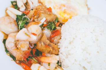 Rice topped with stir-fried combination of pork,squid, shrimp, b