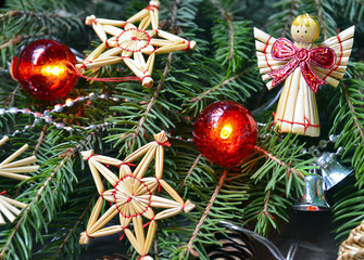 Christmas or New Year decoration with fir tree branches,red garland lights,cones and toys on old wooden background.Winter holidays,Christmas or New Year concept.Selective focus.