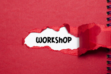The word workshop appearing behind torn paper