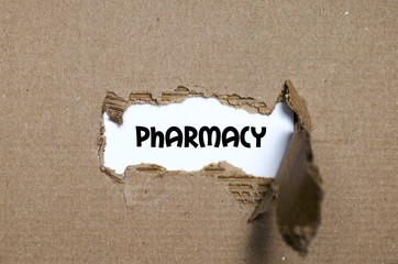 The word pharmacy appearing behind torn paper