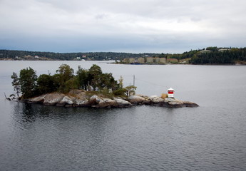 Fototapeta na wymiar Lighthouse on the rocks in the Baltic Sea, Scandinavia
