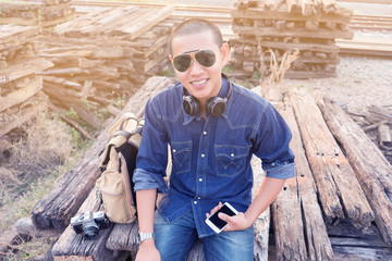 Fototapeta premium Young handsome traveller hipster man with backpack on the street