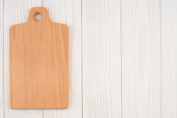 Kitchen board on an old white wooden table.