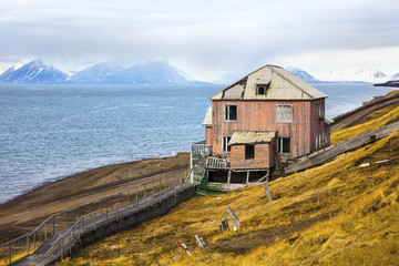 Abandoned house in the harsh arctic nature at summer