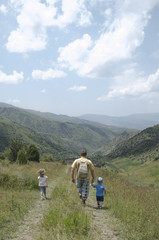 Fototapeta na wymiar father with children walk in mountain