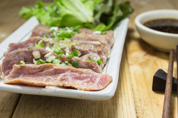 Place the sliced beef on white plate with salad place.