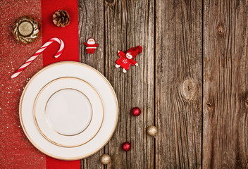 Christmas decoration background over wooden table with red cloth.