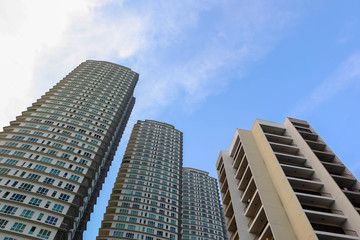 Modern high-rise apartment over blue sky background with color tone effect