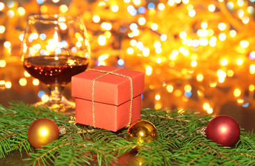 Christmas Composition with Gift box and light, red balls on wooden table