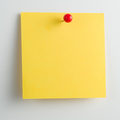 Blank sticky note with pushpin isolated on white background