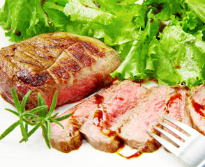 Steak meat grilled with rosemary and lettuce