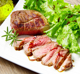 Steak meat grilled with rosemary and lettuce