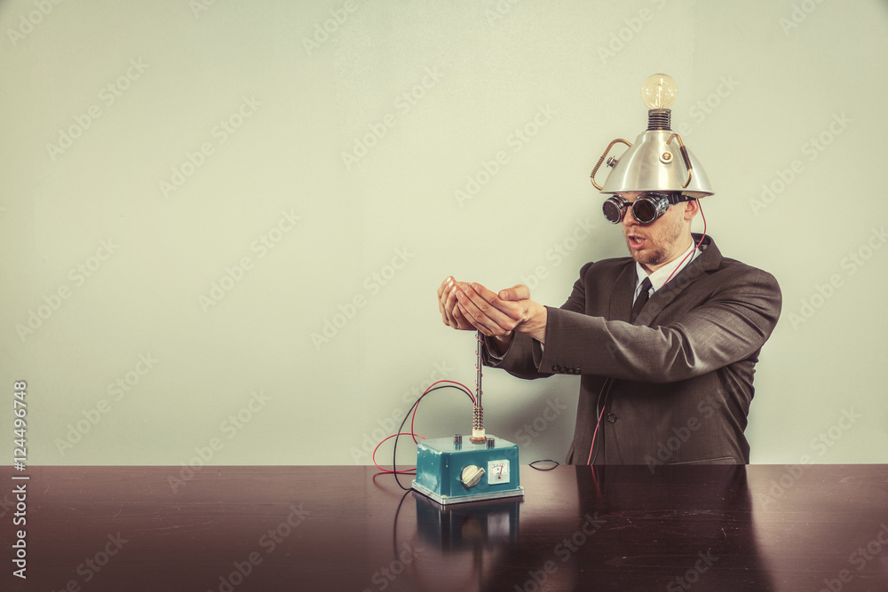 Wall mural businessman sitting at office desk with machine