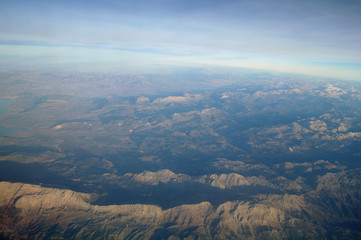 Aerial view above clouds and landscape