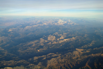 Aerial view above clouds and landscape