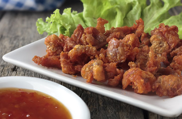 Fried chicken skin on the wooden floor