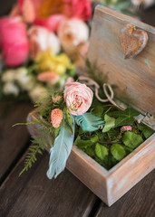 Wooden casket with green plants. Element of a wedding decor.
