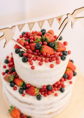 Wedding cake. Cake with fresh berries. Cake with white cream and