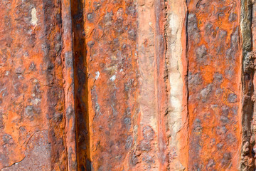 Rusty eroded metal sea defences on coast