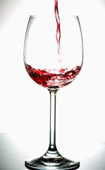 Pouring wine into the glasses, white background, isolated