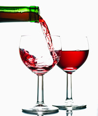 Pouring wine into the glasses, white background, isolated