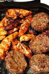 The concept of sunny summer days with Golden chicken & sizzling burgers on a tray ready to eat