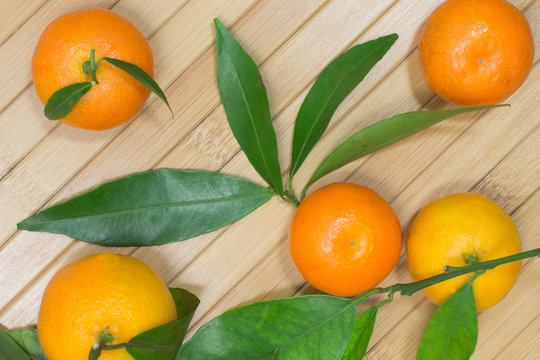 Branch with tangerines on a table