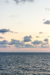 Scenic view of peaceful sea just before the sunset while sky is filled with clouds