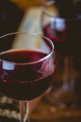 Glass of wine on wooden table, atmospheric composition