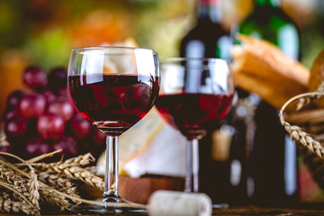 Glass of wine on wooden table, atmospheric composition