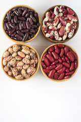 Four kinds of beans on white background. Top view.