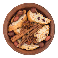 Fototapeta premium Cookies with raisins and nuts in a ceramic plate. Isolated on wh
