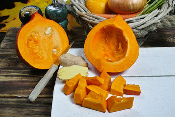 Fresh ingredients for pumpkin soup with apple, orange, carrot and onion