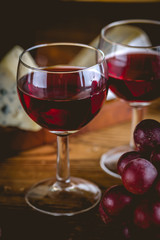 Glass of red wine on wooden table