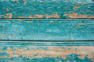 Fototapeta na wymiar sky-blue coloured cracked paint peeling on wood texture.