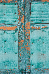 old wooden window shutters in turquoise color.cracked peeling paint. grunge background.