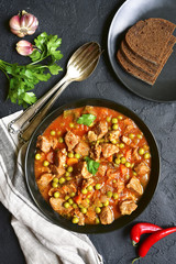Veal stewed with vegetables in tomato sauce.Top view.
