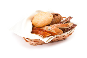 Newly-baked bun with sesame, piece of of white and black bread in a basket.