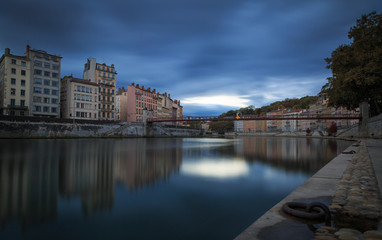 Dark clouds above the Saone river and .Passerelle Saint-Vincent in Lyon at dusk.