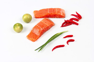 Ready raw fresh salmon and spicy sour herb for cooking isolated on white background 