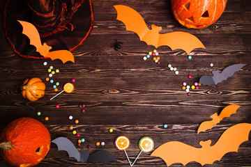 Naklejka premium Halloween holiday background with pumpkin and bats.