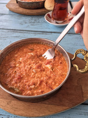 traditional breakfast with omelet and turkish tea on wooden tabl