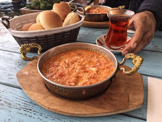 traditional breakfast with omelet and turkish tea on wooden tabl