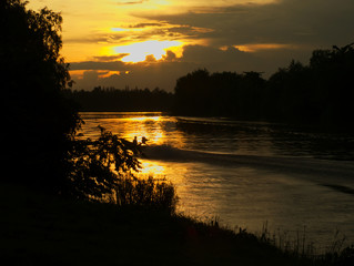 riverside view with sunset and long-tail boat