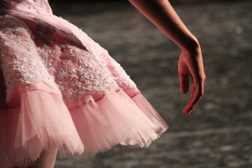 Close-up of a ballerina waiting behind stage to perform